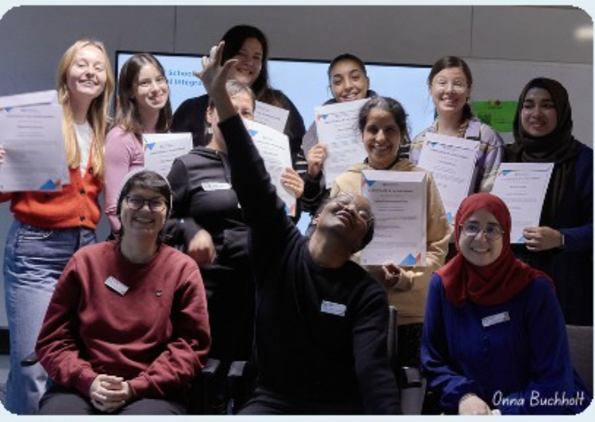 ReDI School graduates holding their certificates